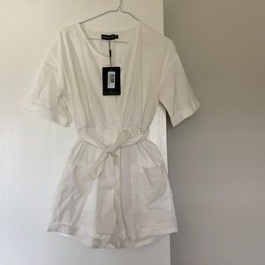 Cream romper with tie and front pockets